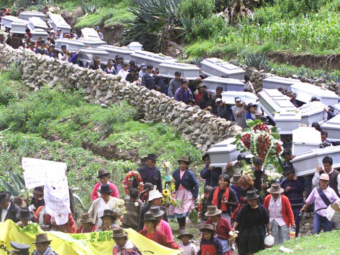 ANDEAN PEOPLE CARRY THE COFFINS OF THEIR RELATIVES BEFORE A FUNERAL INLUCANAMARCA.